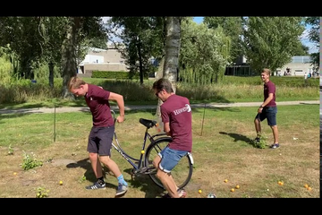 Biking with an imaginary frying pan (the box full of pingpong balls)